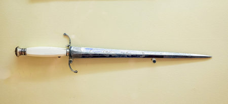 A sword isolated on a yellow background