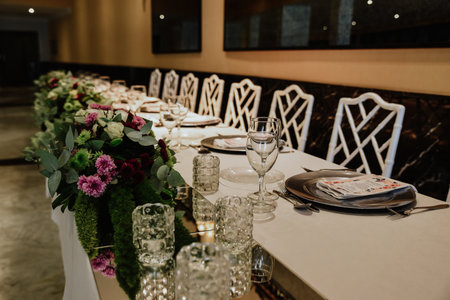 A closeup shot of a wedding table decorated with natural flowersの写真素材