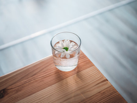 A closeup shot of a white daisy in a glass of waterの写真素材