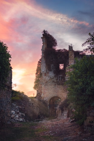 A vertical shot of the ruins of an old building captured under the colorful skyの写真素材