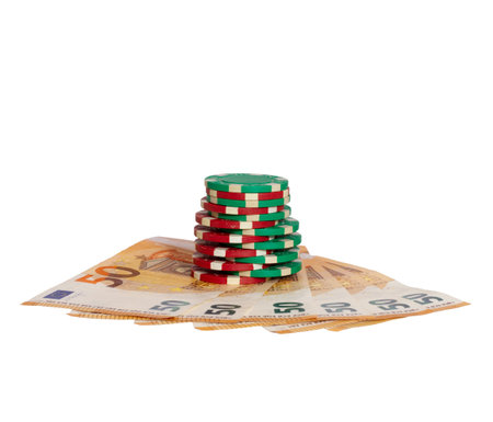 A closeup shot of 50 euro banknotes and poker chips isolated on white backgroundの写真素材
