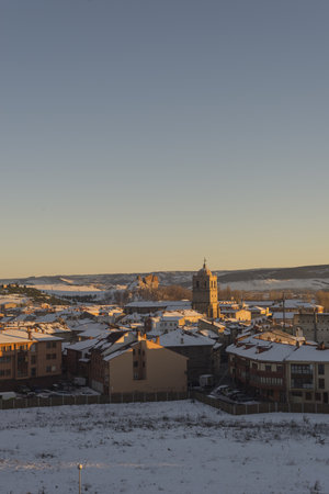 A vertical shot of the city of Palencia in Spain covered in snow