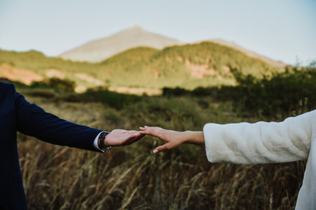 A closeup shot of newlyweds holding their handsの写真素材