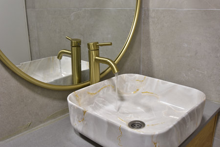 A close-up shot of a bathroom interior in cozy colors with a modern bathtubの写真素材