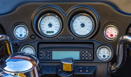 A closeup shot of a black motorcycle dashboardの写真素材
