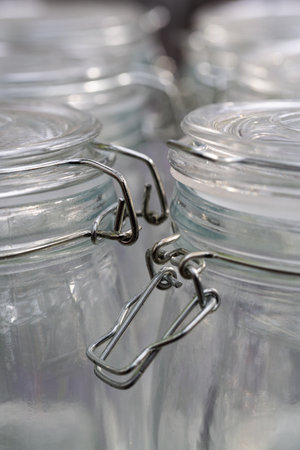A vertical shot of the lids of mason jars grouped together in the kitchen