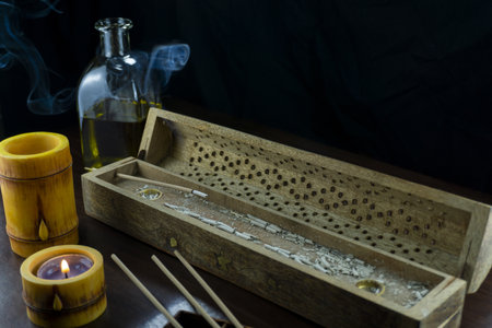 A Buddhist corner with candles and bamboo skewers in a boxの写真素材