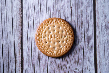 A top view of a fresh Maria cookie (galleta Maria) on a wooden sur