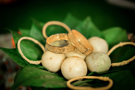 Gold Wedding ring inside green leaf vessel