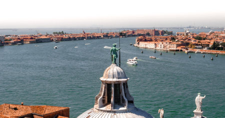 The belltower of Saint George monastery with a view of Giudecca Canal and coastal line of Venetoの写真素材