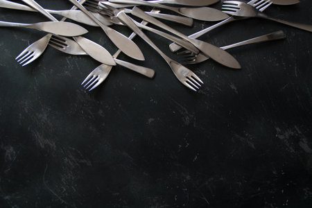 Top view of cutlery on a dark wooden background on top.Free space for your text, copy space
