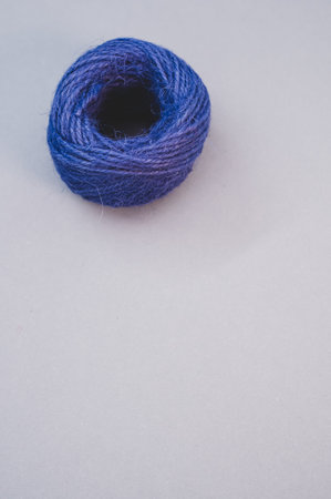 A vertical shot of a blue thread yarn isolated on a grey backgroundの写真素材