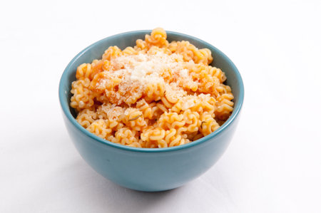small radiatorre pasta with tomato sauce in a vegetarian meal with parmesanの写真素材