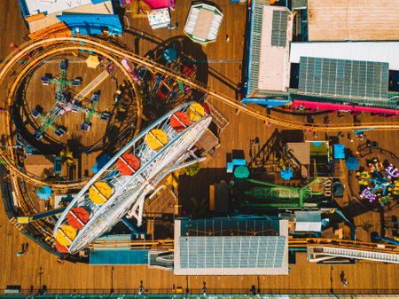 An aerial view of the Santa Monica amusement park with a roller coaster and ferris wheel near Venice beach in Los Angeles, Californiaのeditorial素材