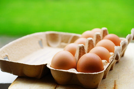 A selective focus shot of some fresh eggs in a box