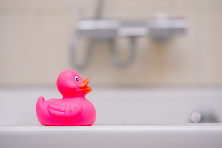 A closeup shot of a pink duck toy in the bathroomの写真素材