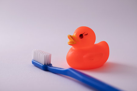 A shot of a toothbrush with duck toy isolated on white backgroundの写真素材