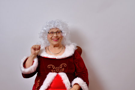 An American female Claus with a bright, happy look on white backgroundの写真素材