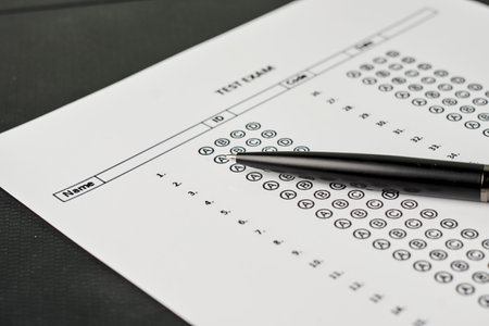 A closeup of a black pen on an exam test's answer sheetの写真素材