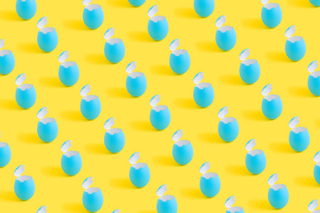 Blue eggshells isolated on yellow background