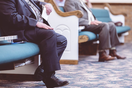 A closeup shot of two people sitting in a conference hallの写真素材
