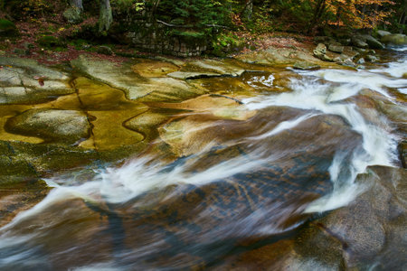 Autumn view of Mumlava river and waterfalls near Harrachovの写真素材