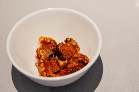 A bowl of Spanish traditional chopped fried bacon strips Torreznosの写真素材
