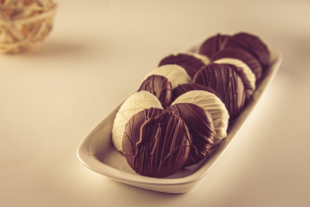 A plate of delicious cookies covered with brown and white chocolate