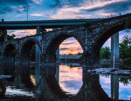 A beautiful shot of an arched bridge during sunsetの写真素材