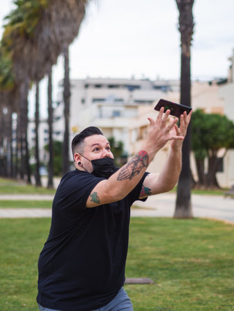A shot of a Caucasian man from Spain dropping down the phone in the streetの写真素材