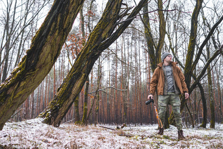 A closeup shot of a Caucasian photographer on the snowy mountainsの写真素材