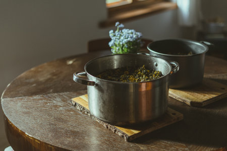 A closeup shot of homemade dandelion syrup on a stainless potの写真素材