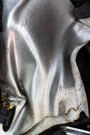 A closeup of wavy deformed silver-colored metalの写真素材