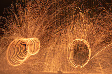 A closeup shot of glowing sparks from spinning steel woolの写真素材