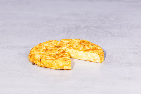A traditional Spanish omelet on a tableの写真素材