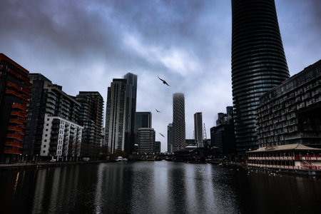 The modern buildings by the river on a cloudy day in London, UKの写真素材