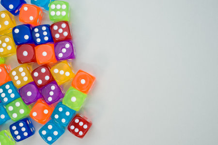 A top view of colorful dices isolated on light gray backgroundの写真素材