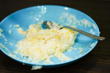 Rice and apple pieces in a blue bowlの写真素材