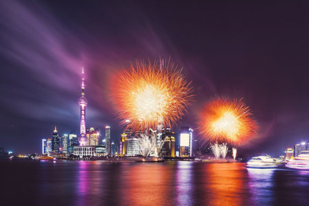 A mesmerizing view of the Shanghai city with colorful fireworks and light at nighの写真素材
