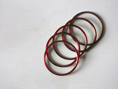 A group of traditional red glass bangles isolated on white background