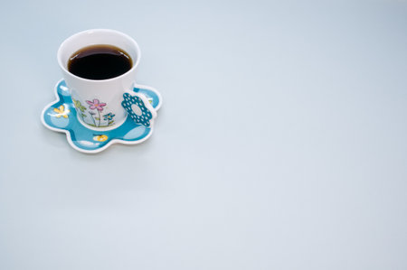A cup of coffee isolated on blue backgroundの写真素材