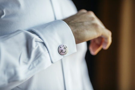 A shallow focus of a man's shirt cuff