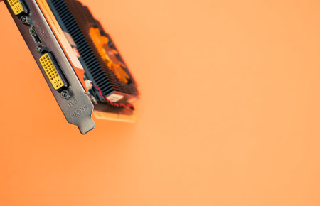 A closeup shot of a computer graphics card on an orange backgroundの写真素材