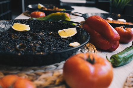 A closeup shot of frying pans and vegetables on the kitchenの写真素材