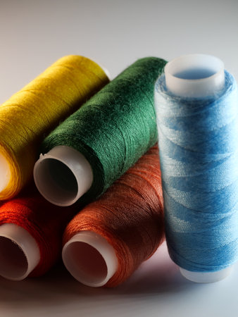 A vertical shot of colorful sewing threads