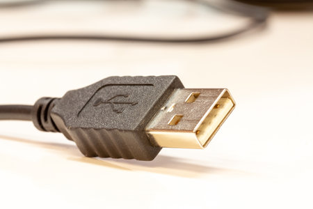 A closeup shot of a black USB cable on a white backgroundの写真素材