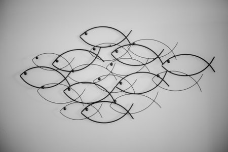 Matte metal wall decor with small fish arranged into a big oneの写真素材