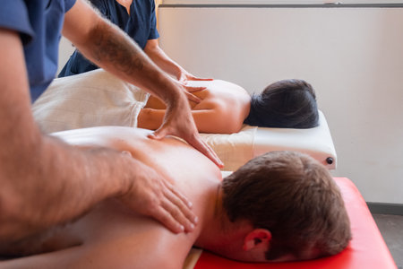 couple massaged, by two male and female masseurs, doing massage on the neck and cervical headの写真素材