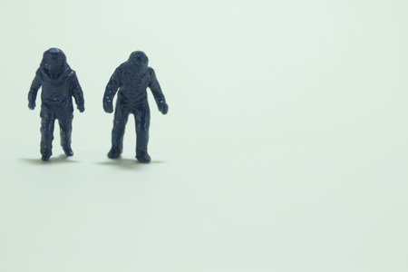 A minifigures of two walking people in bomb suits /miniature peopleの写真素材
