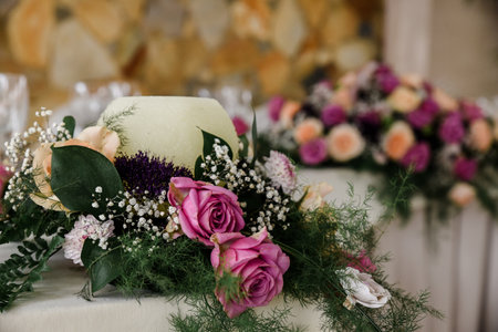A closeup shot of a wedding table decorated with natural flowersの写真素材